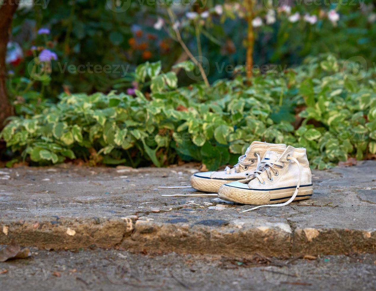 pair of very old white sneakers photo