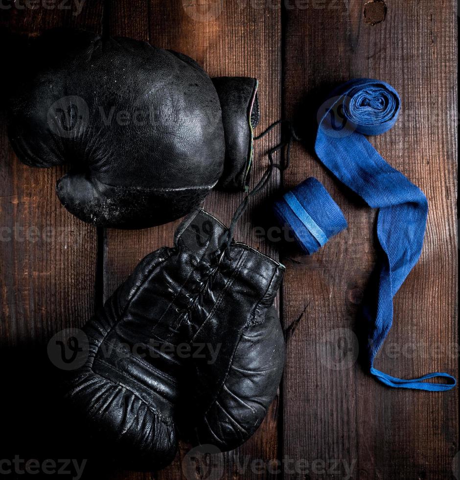 pair of very old black leather boxing gloves photo