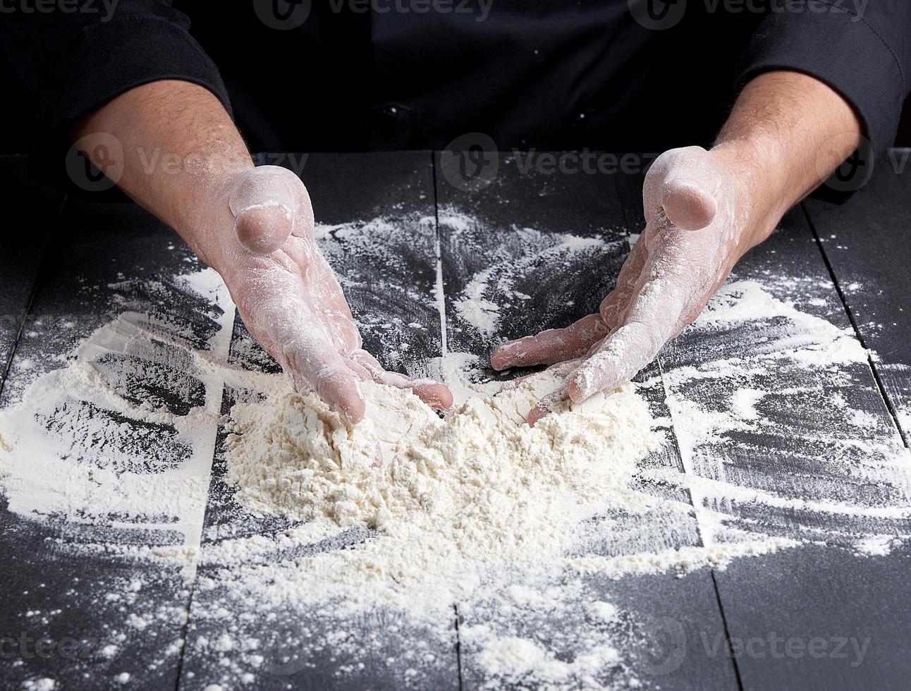 white wheat flour scattered on a wooden wooden table photo