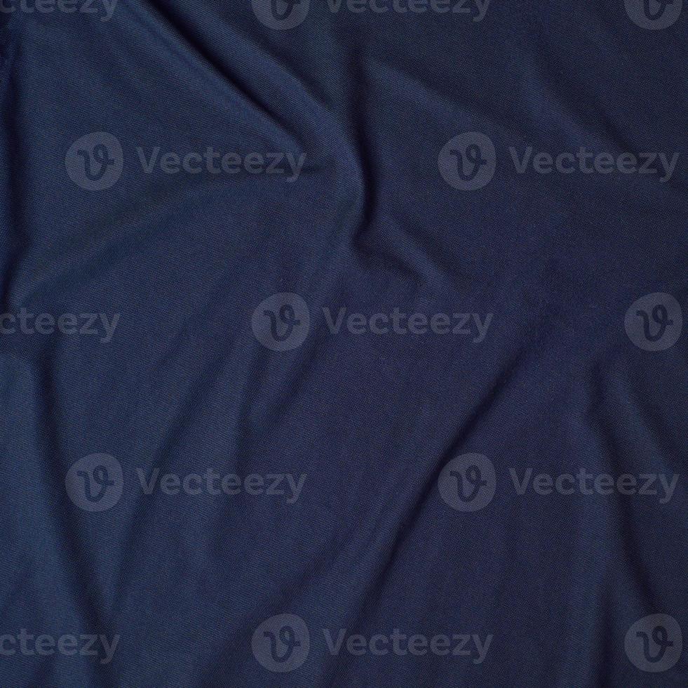 fragment of crumpled cotton blue fabric, full frame photo