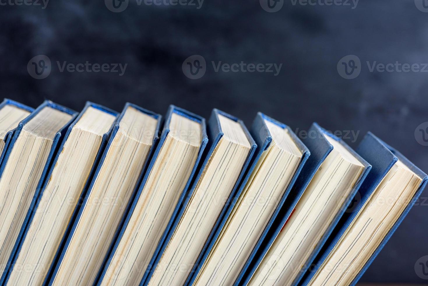 books with blue cover, black background photo