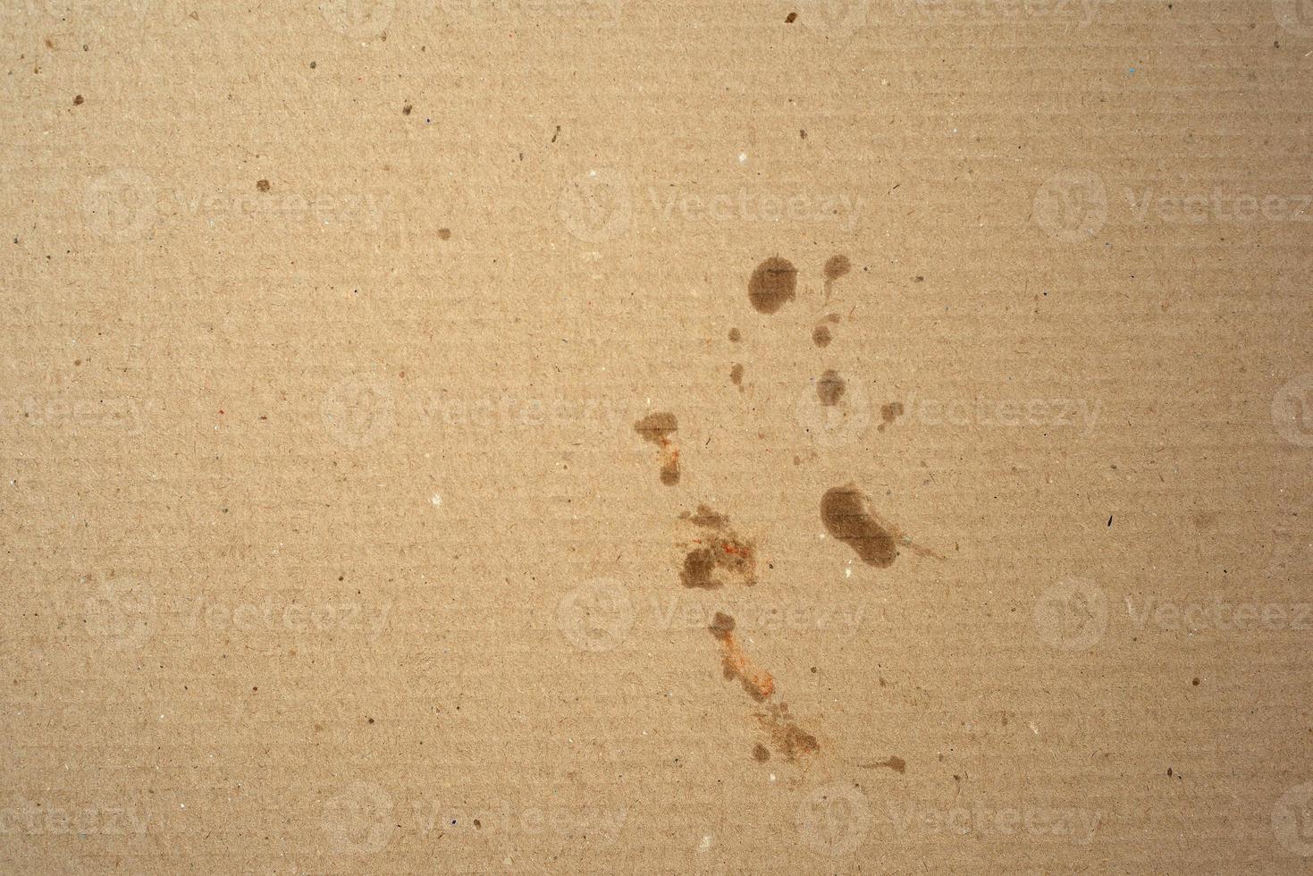 fragment of a brown paper sheet of a box with greasy stains, photo
