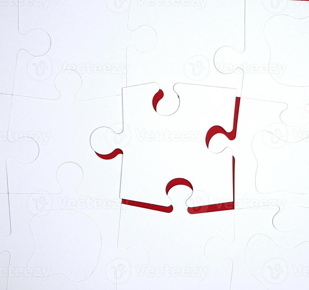 white large blank puzzles on a red background, top view photo