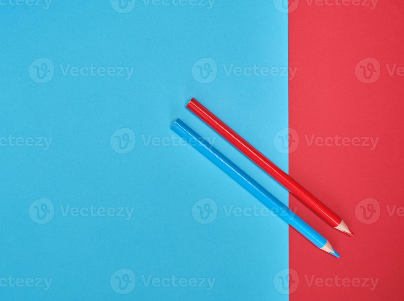 red and blue wooden pencils on color abstract background photo