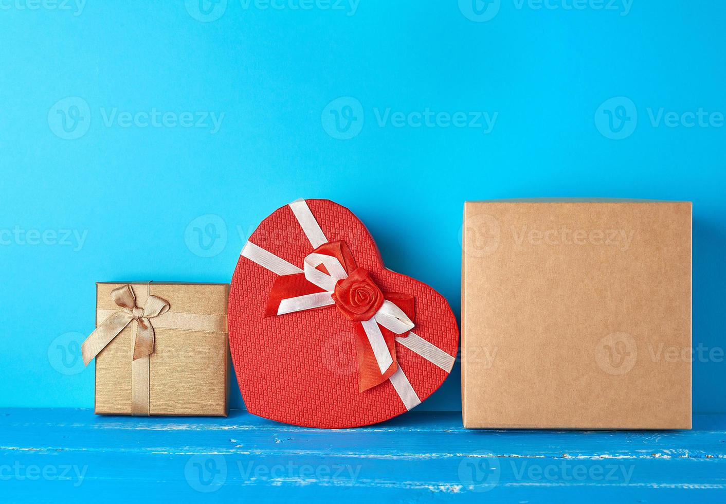 various cardboard boxes on a blue background, festive backdrop photo