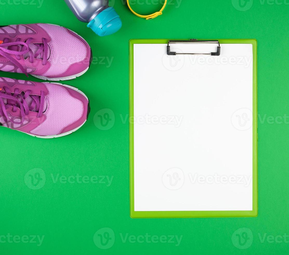 sports women's clothing for sports and fitness, top view, green background photo