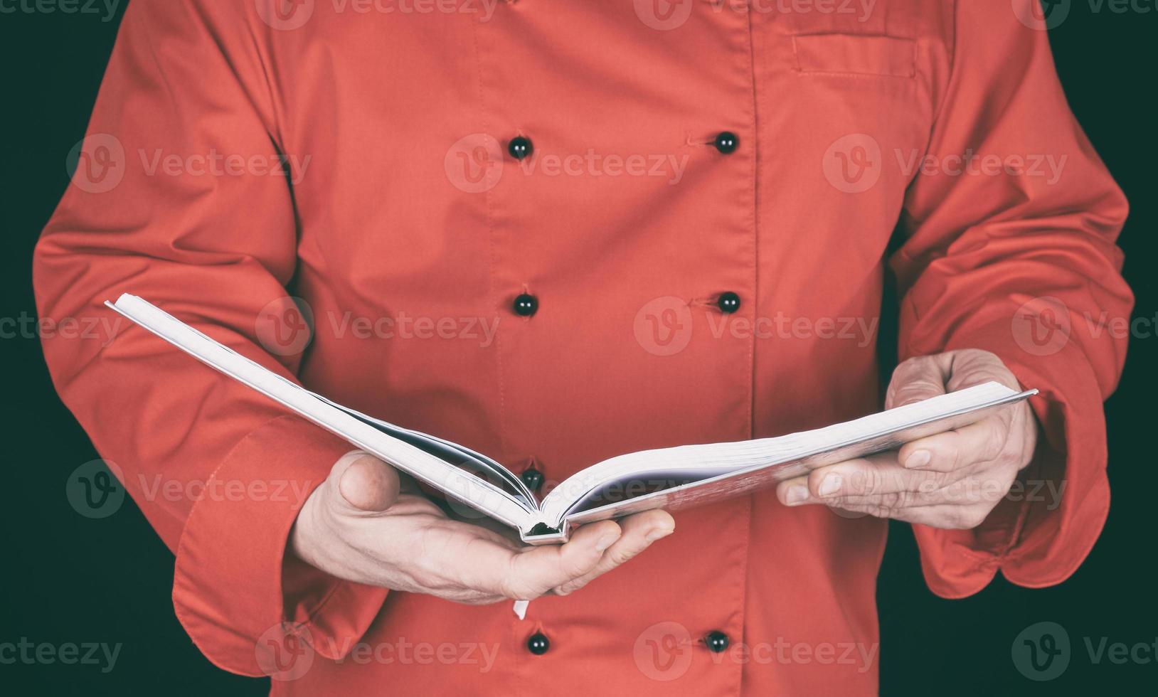 chef in red uniform holding open notepad photo