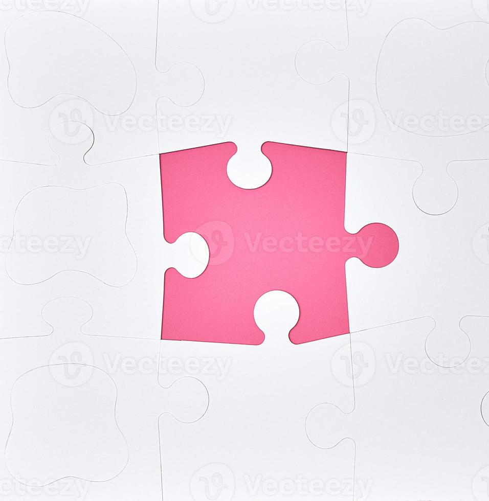 grandes rompecabezas blancos en blanco sobre un fondo rosa, vista superior foto