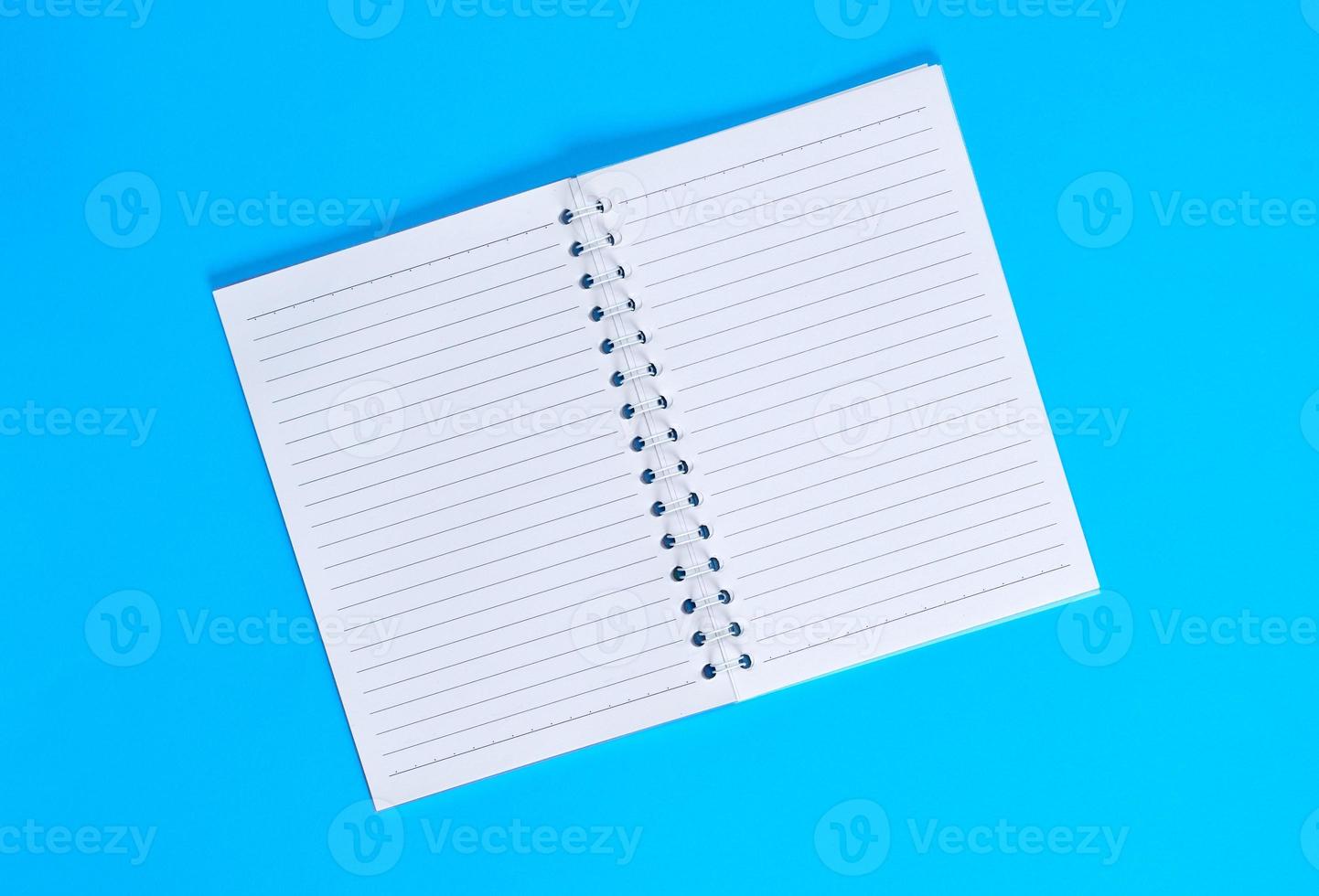 notebook with empty white sheets in line photo