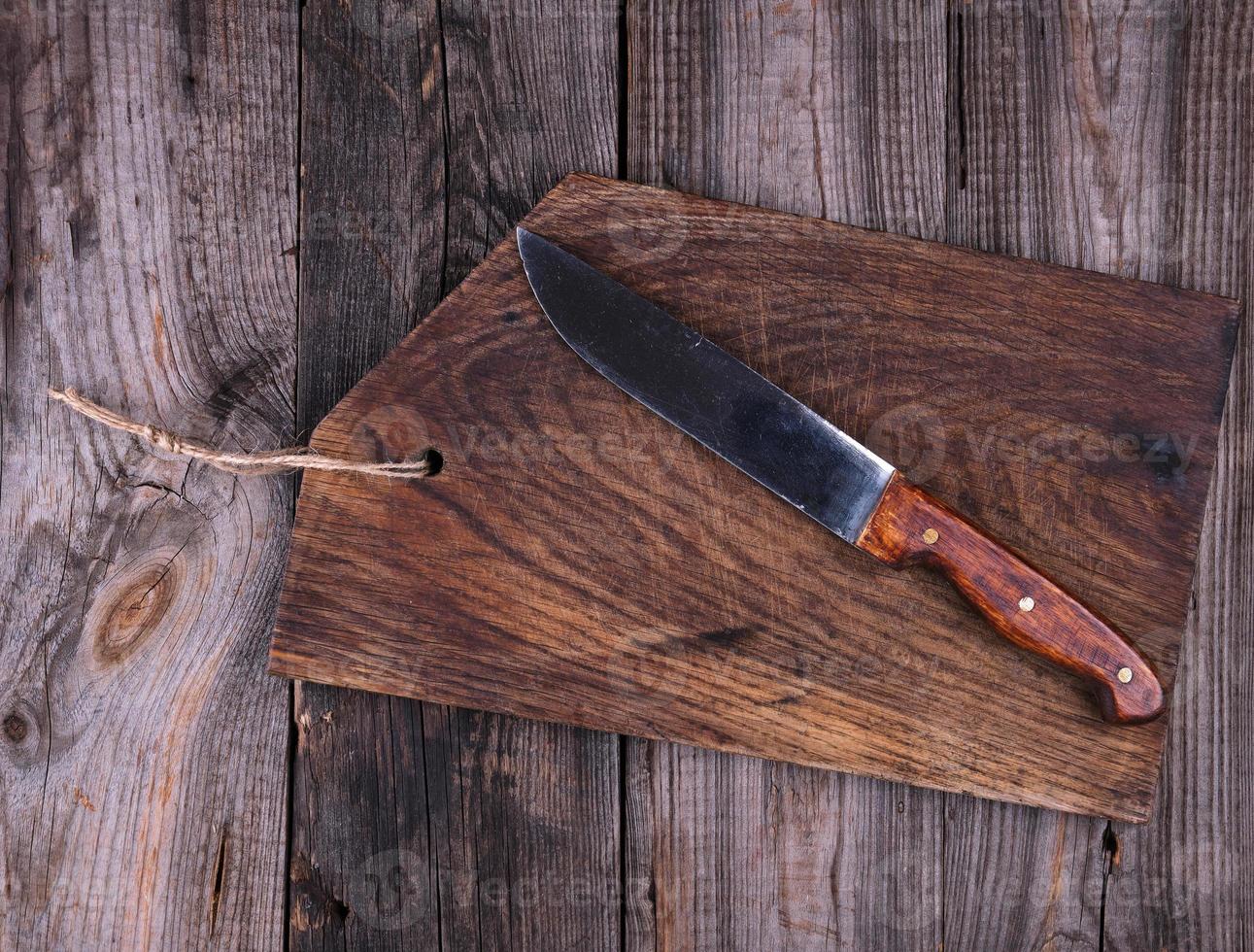 empty old brown wooden cutting board and knife photo