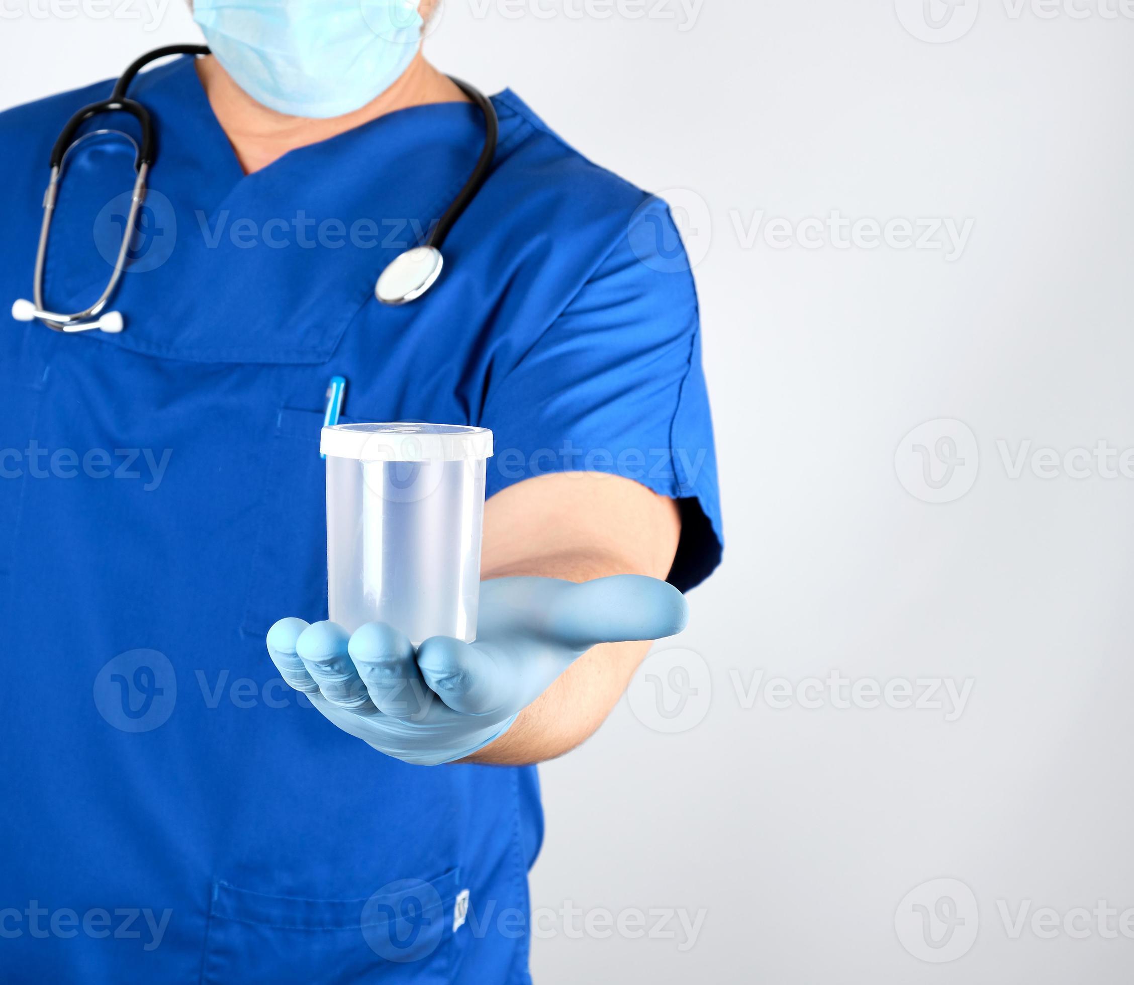 doctor in blue uniform and latex gloves is holding an empty plastic
