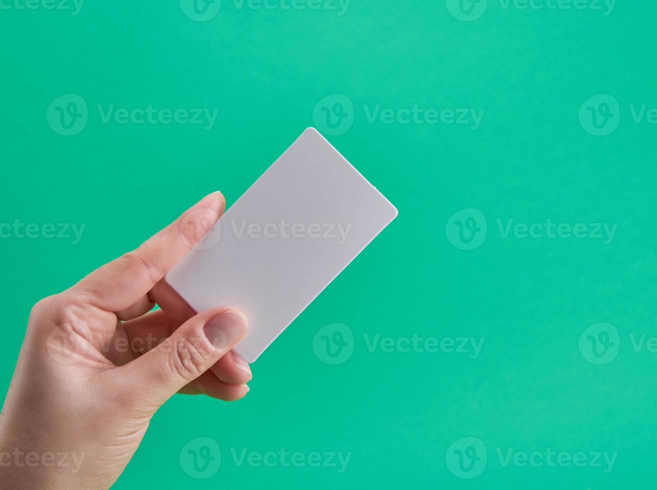 white paper business card in a female hand photo