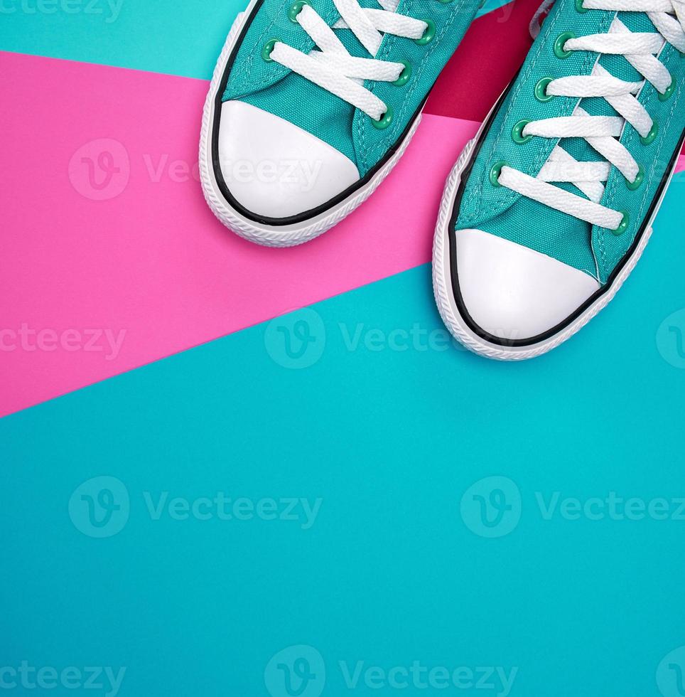 pair of blue textile sneakers on an abstract multicolored background photo