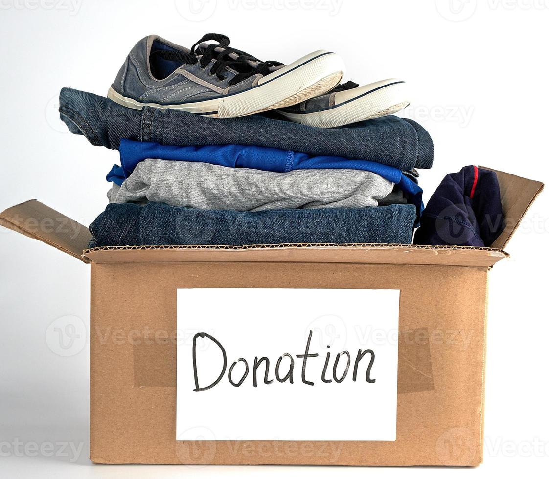 folded clothes and shoes in a brown paper box photo