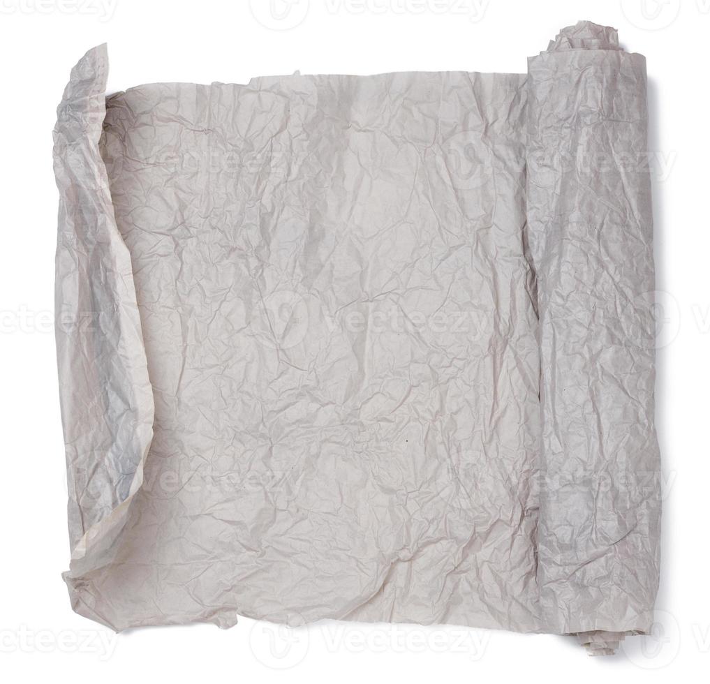 Roll of gray crumpled paper isolated on white background photo