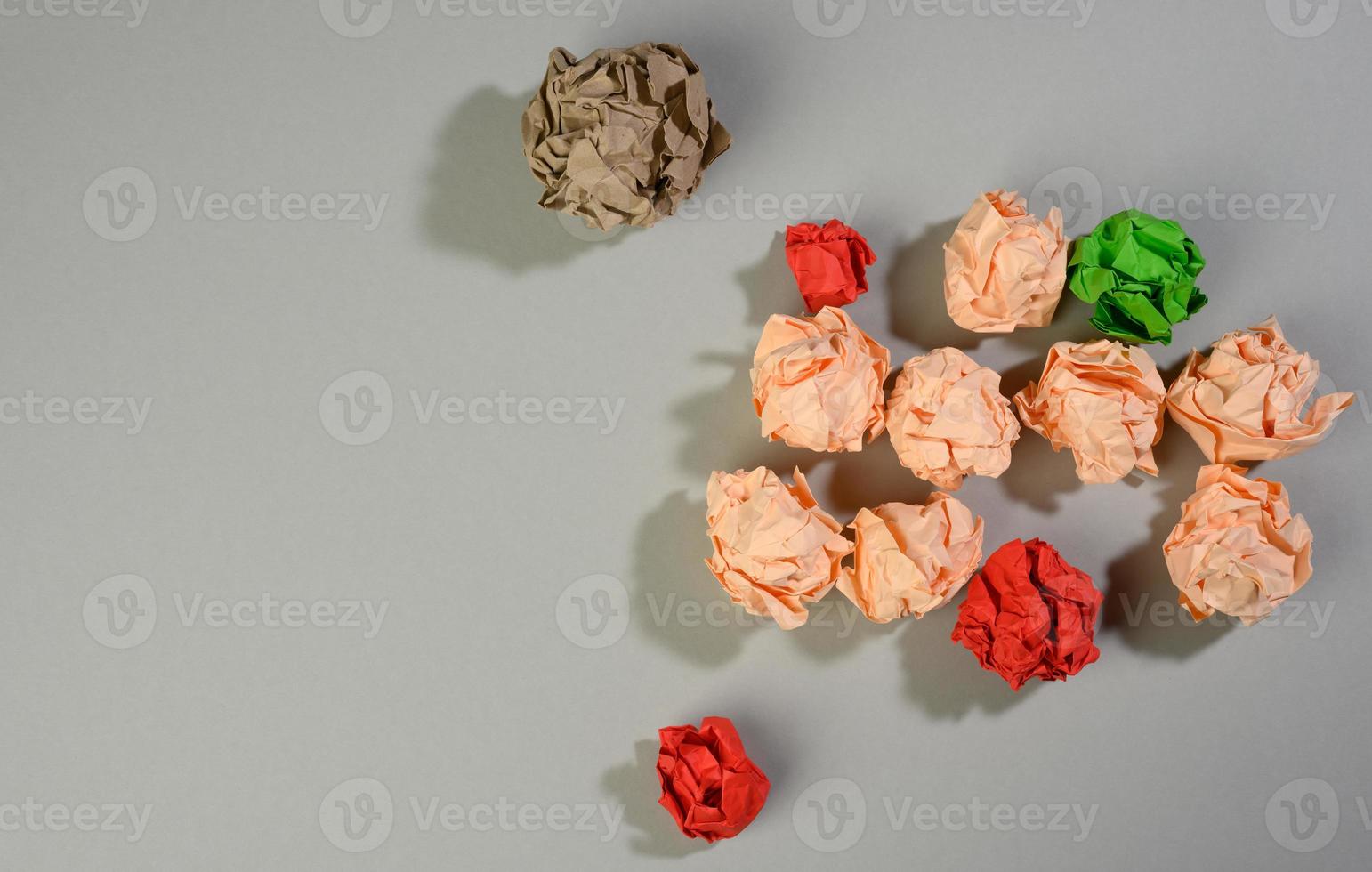 crumpled balls of paper on a gray background, top view. The concept of finding innovative ideas, the right solutions photo