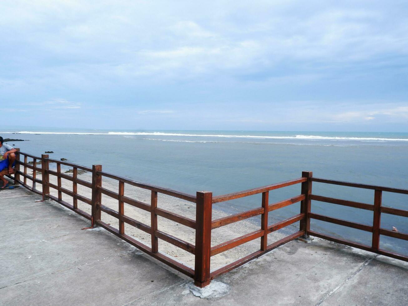 Beautiful Beach View From the top of the wooden Bridge. Blue sky, beautiful turquoise water photo