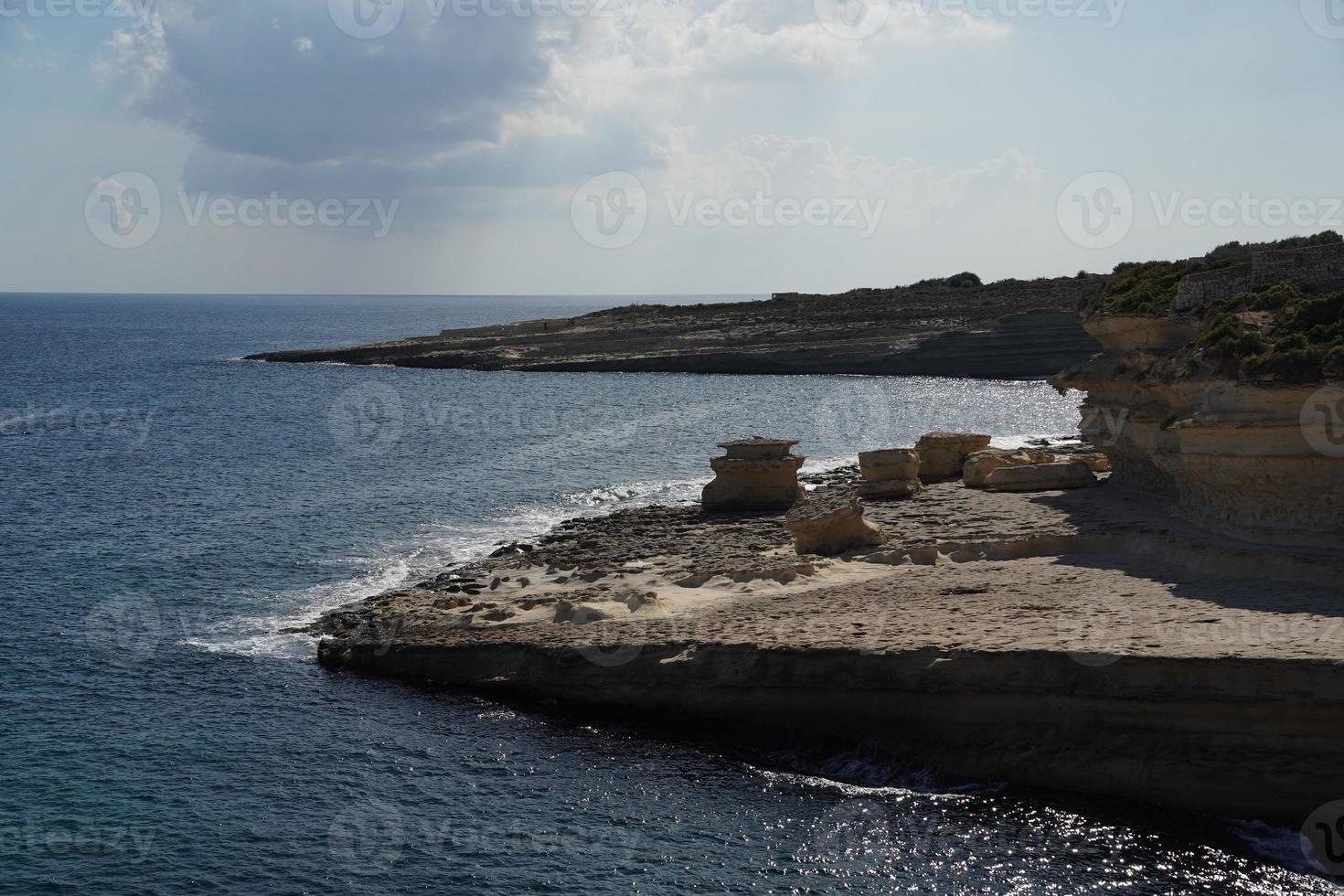 saint peter pools Malta rock formation hole on rocks photo