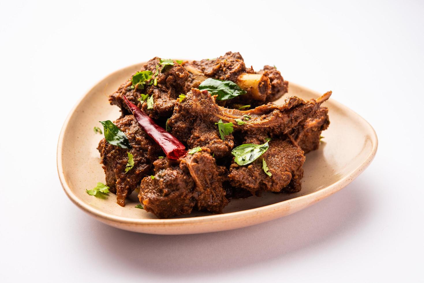 Sukha mutton or chicken, dry spicy Murgh or goat meat served in a plate or bowl photo