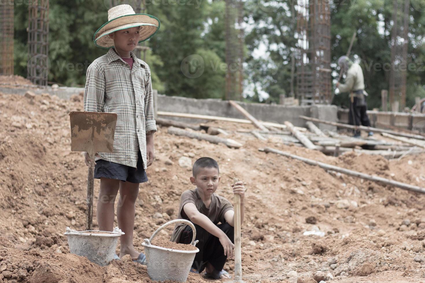 Children are forced to dig, work because of poverty. Violence children and trafficking concept,Anti-child labor, Rights Day on December 10. photo