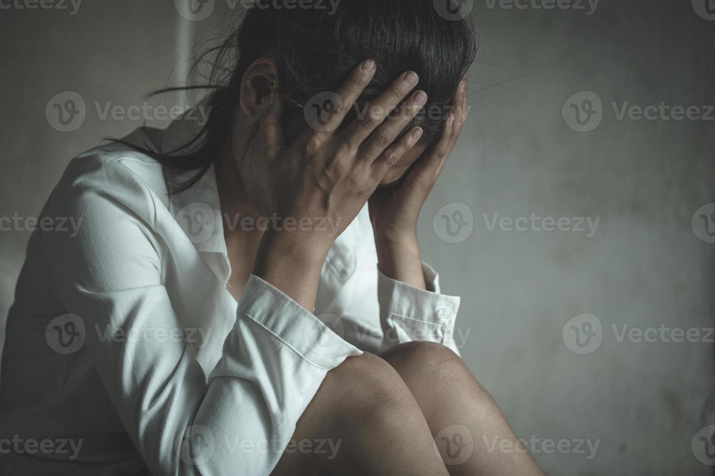 Young depressed woman, domestic and rape violence,beaten and raped sitting in the corner, Domestic violence. photo