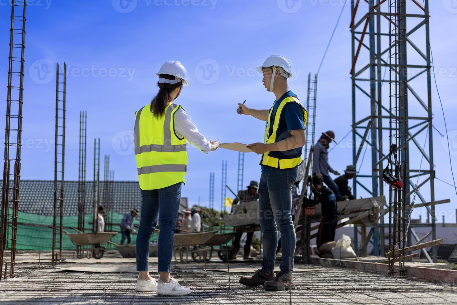 Team of engineering architect inspector and contractor having discussion while examining the quality of construction work of real estate development project concept photo