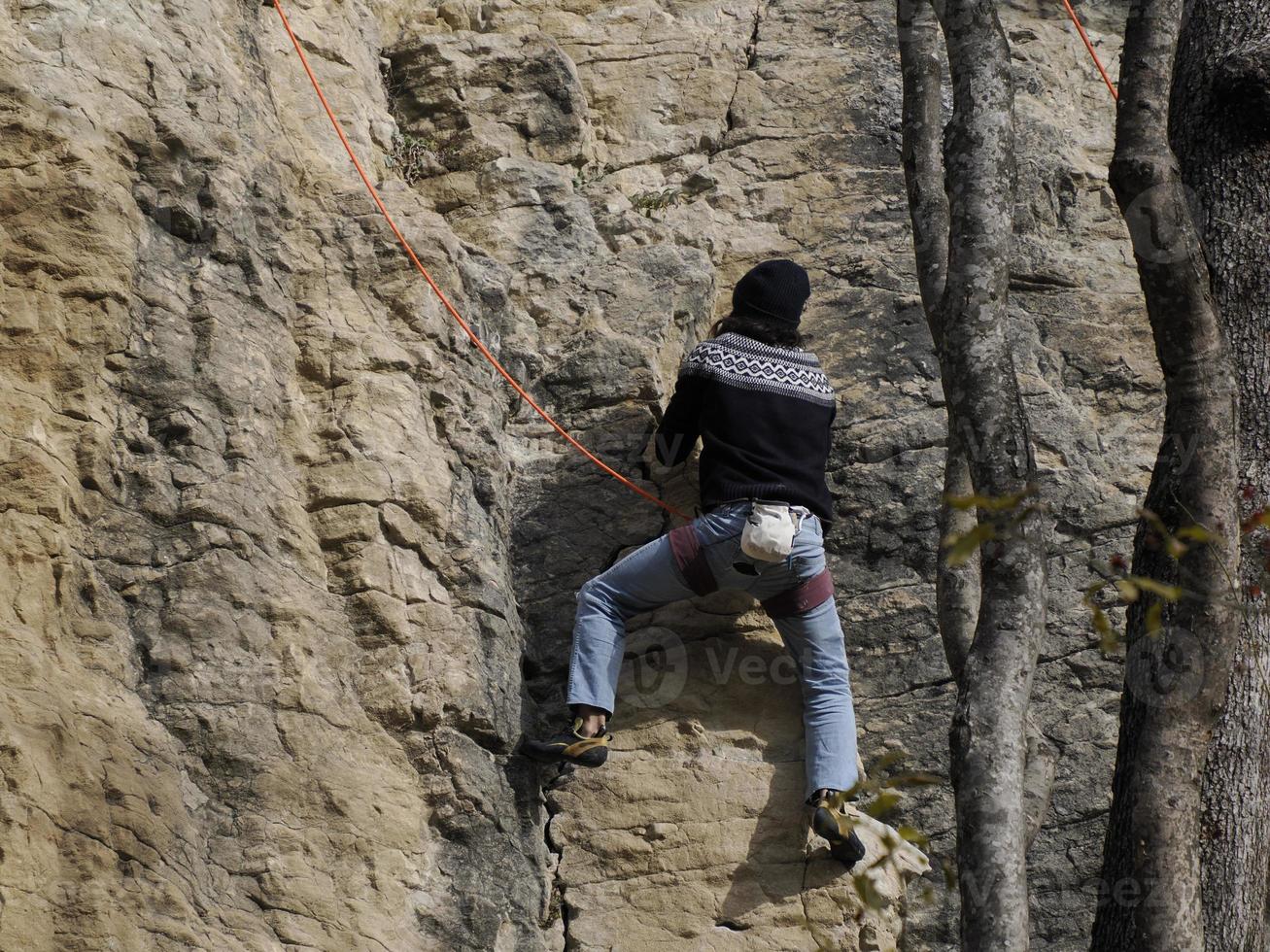 Rock Climber climbs on the Bismantova Stone in the Tosco Emiliano Appennino Park photo
