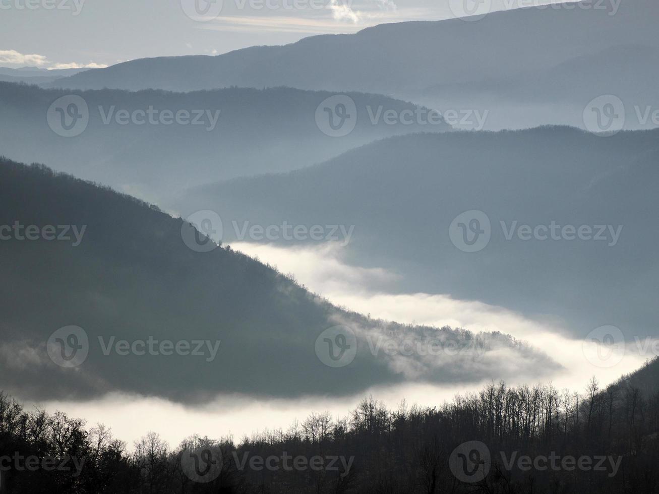 Low clouds like fog in appennines valley around Bismantova stone a rock formation in the Tuscan-Emilian Apennines photo