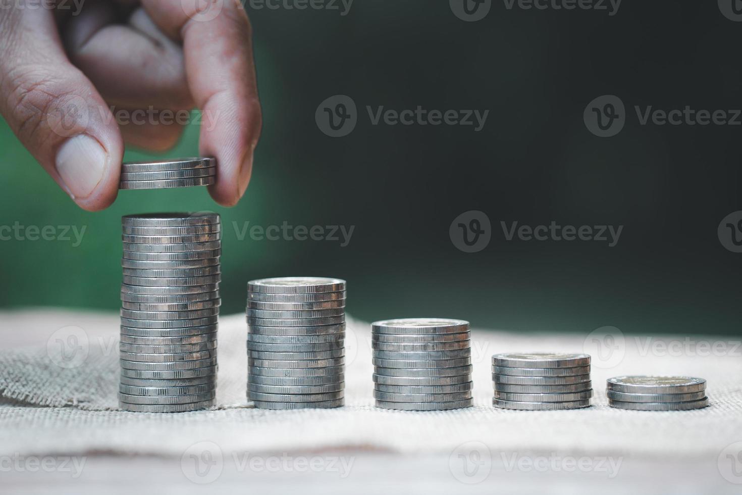 women hand put money coins to stack of coins. Business Growth concept. photo