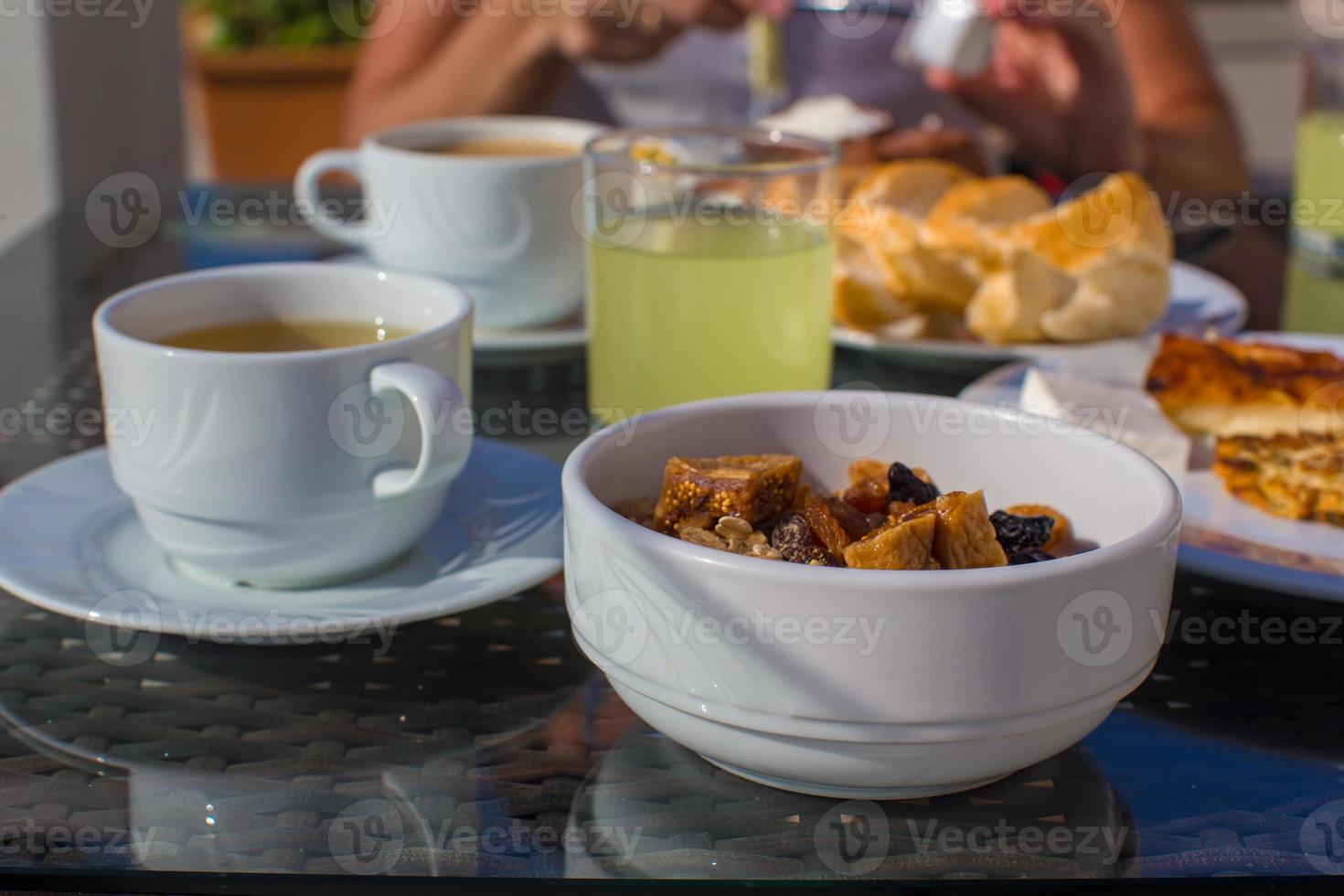 Delicious breakfast with flakes,dried fruit and cup of hot coffee photo