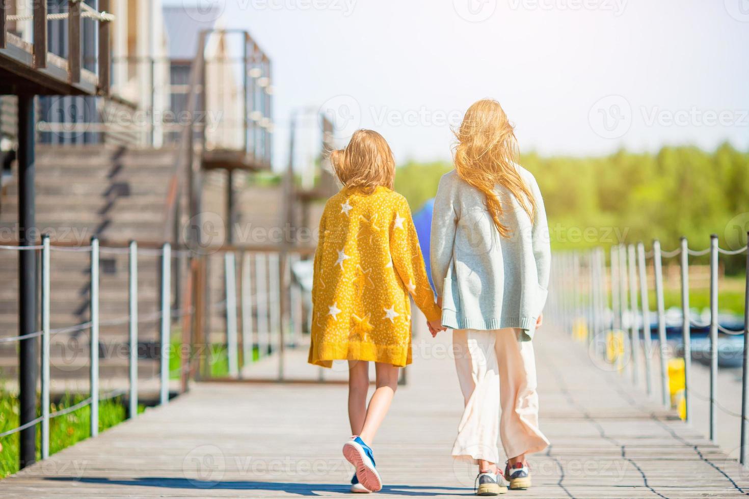 Adorable little girls in port on vacation photo