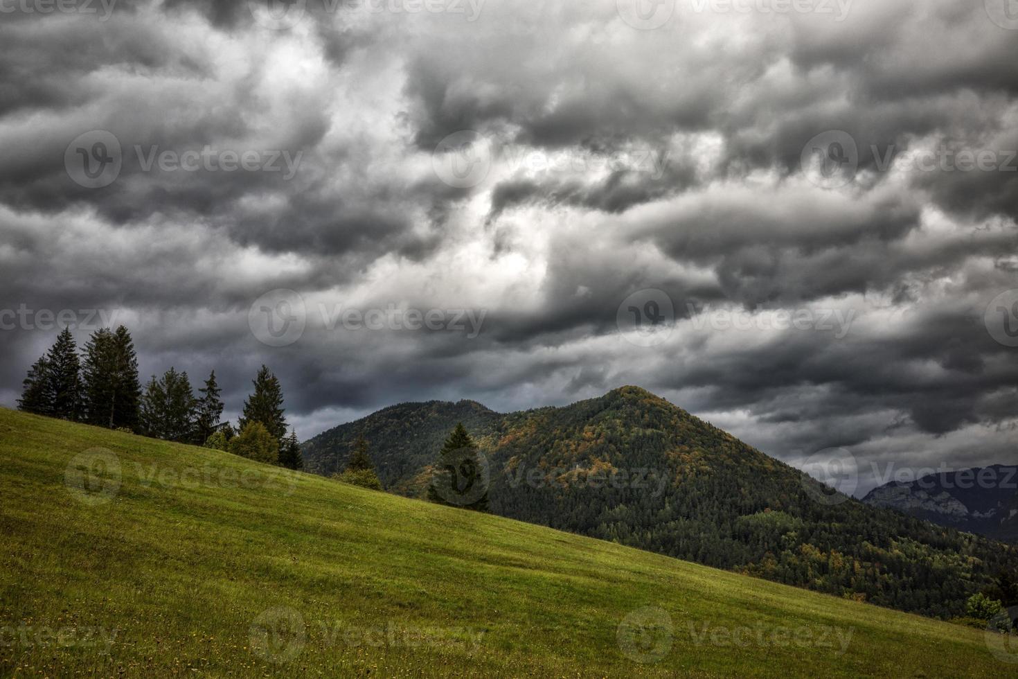 Stormy clouds on sky and hill at background. Autumn country. photo