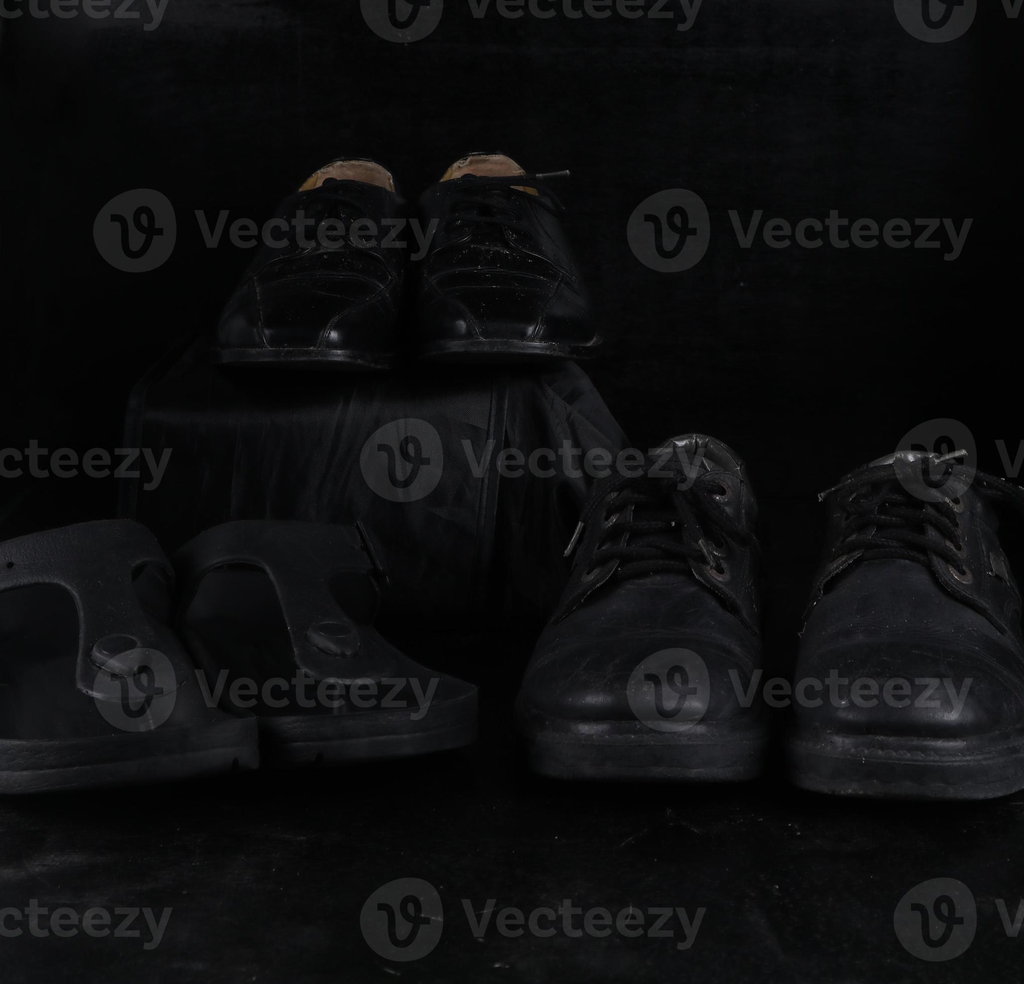 Pair of black male classic shoes on black background. Dusty shoes