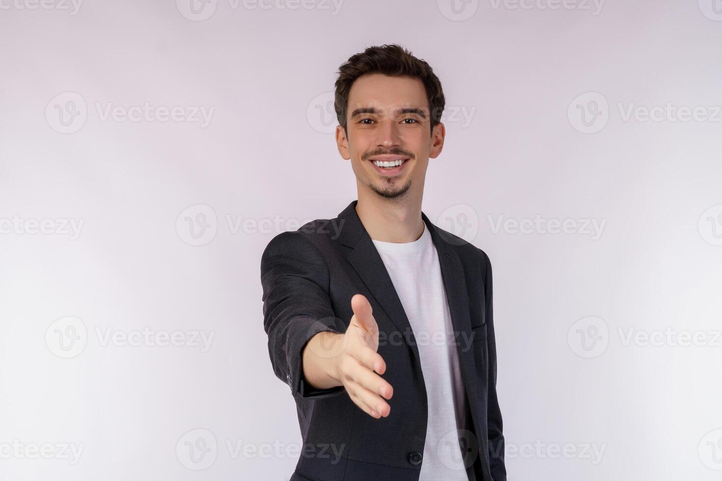 Portrait of smiling handsome businessman extend hand for handshake, look friendly, greet you, hi gesture, standing over white background photo