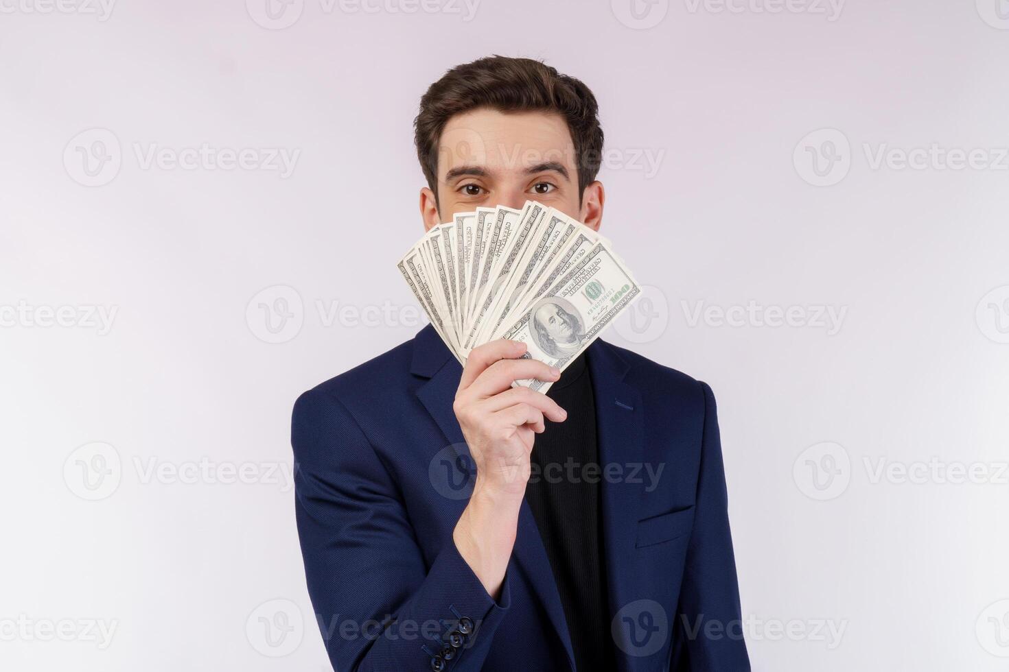 Portrait of a cheerful man holding dollar bills over white background photo