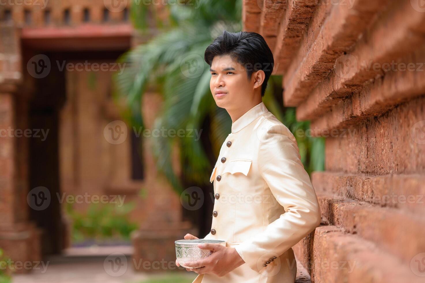 Portrait handsome man in Songkran festival with water bowl photo