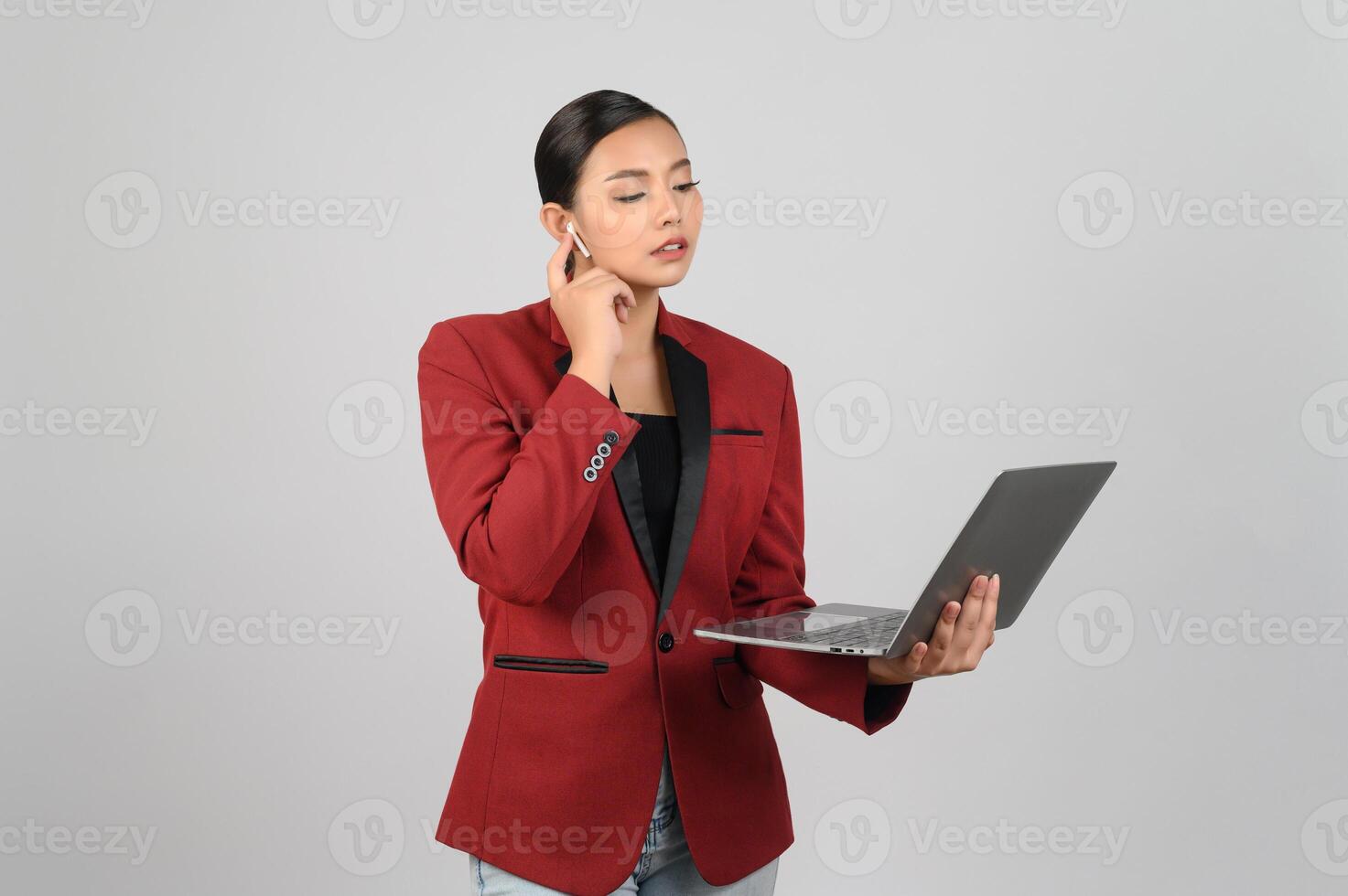 Young beautiful woman in formal clothing for officer use laptop and earphone photo