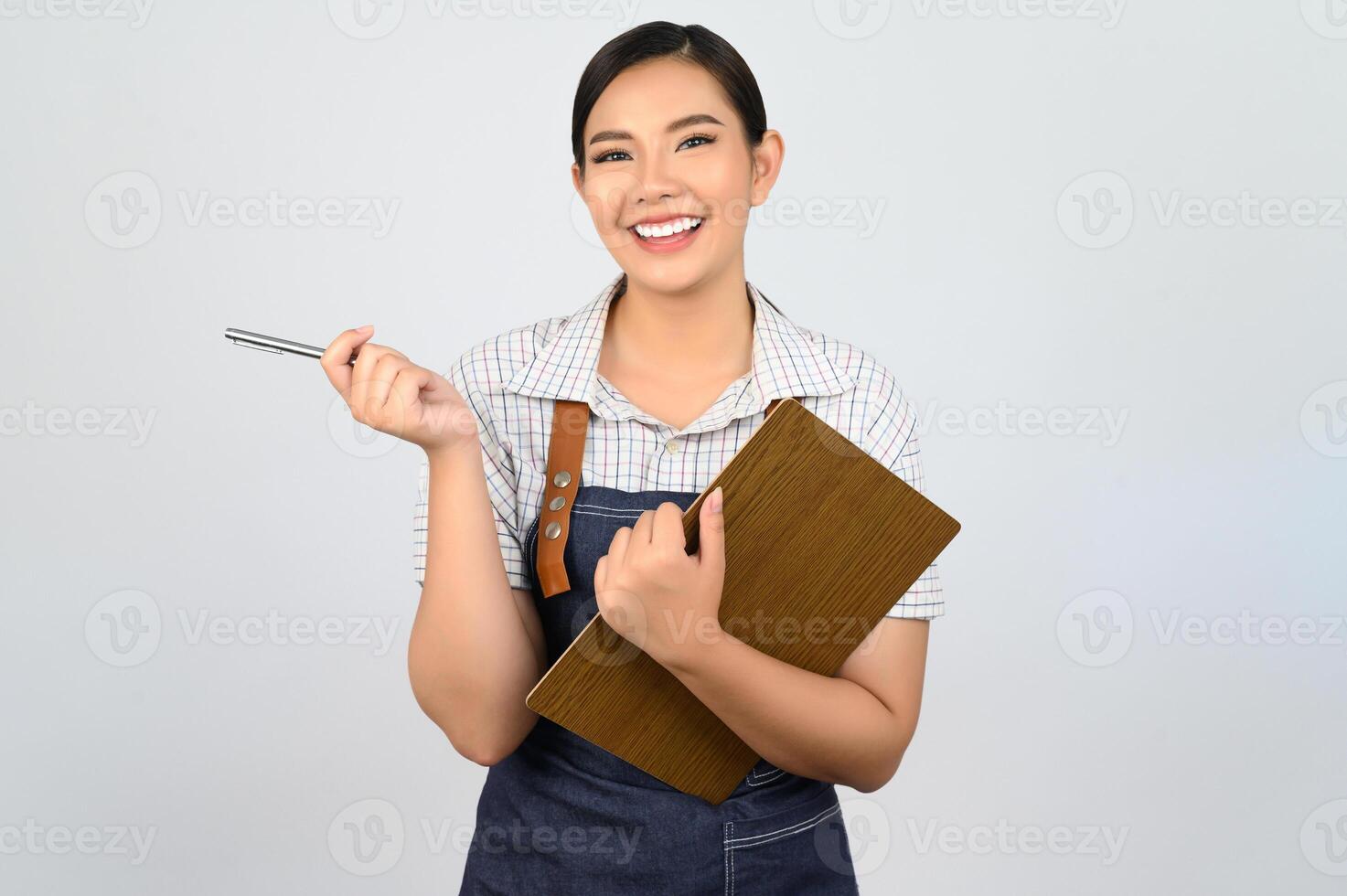 Portrait of young asian woman in waitress uniform pose with clipboard photo