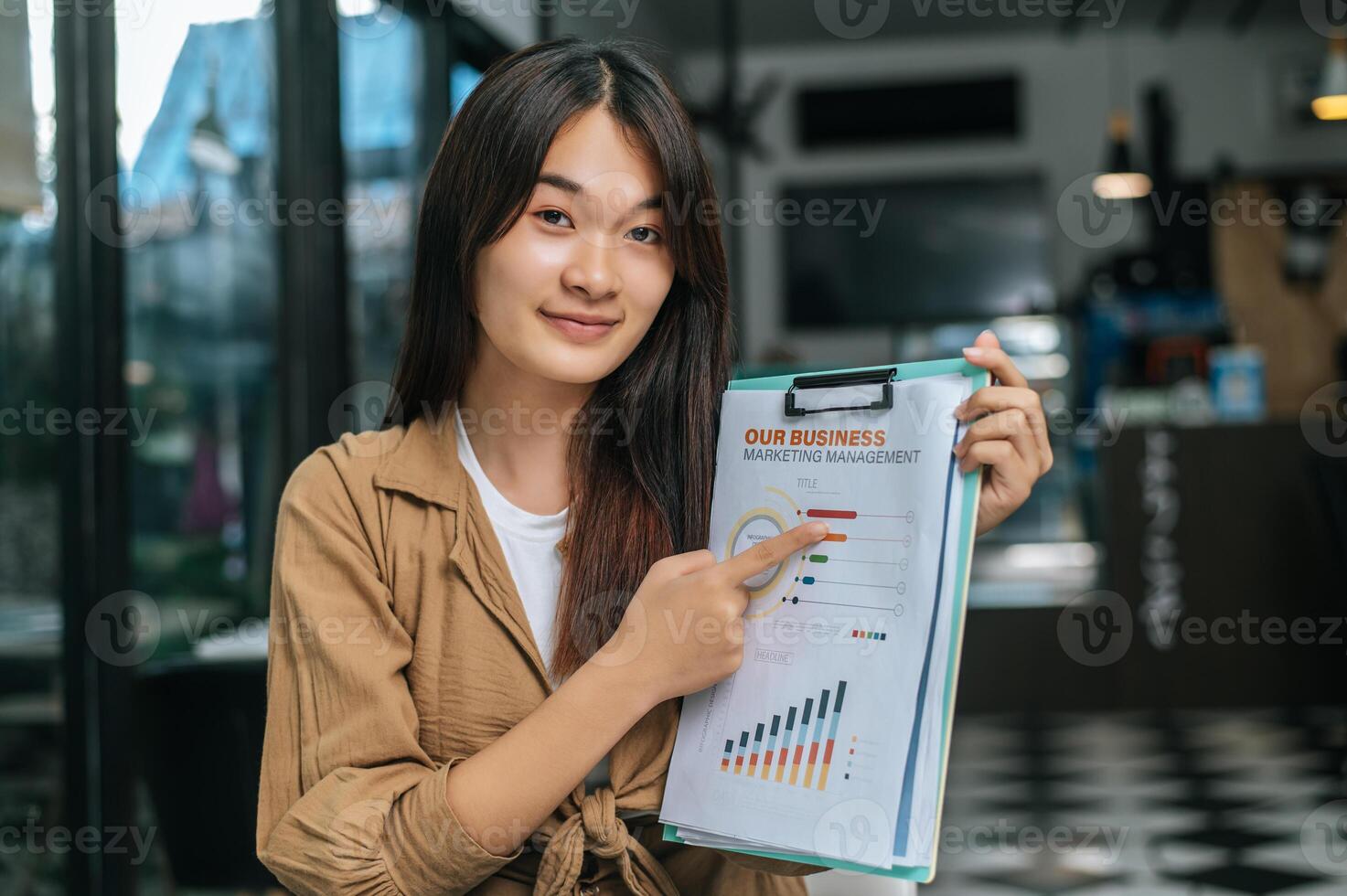 Young woman show report while presenting photo