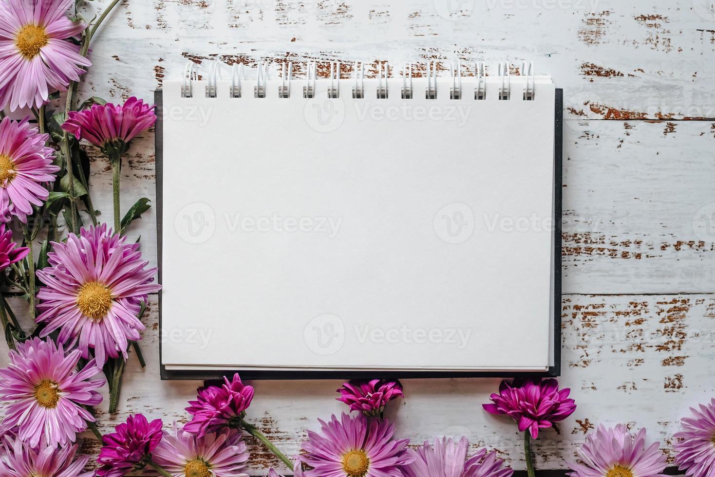 pink flowers frame, white wood background with copy of space photo