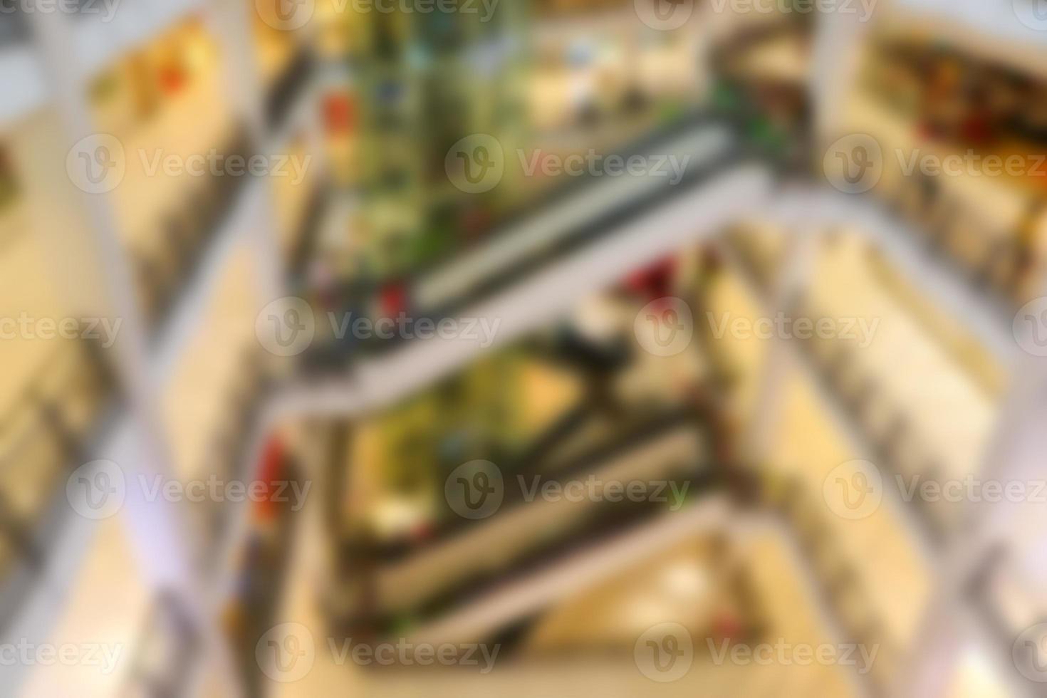 Blurred background of shopping mall center. People shopping in department store. photo