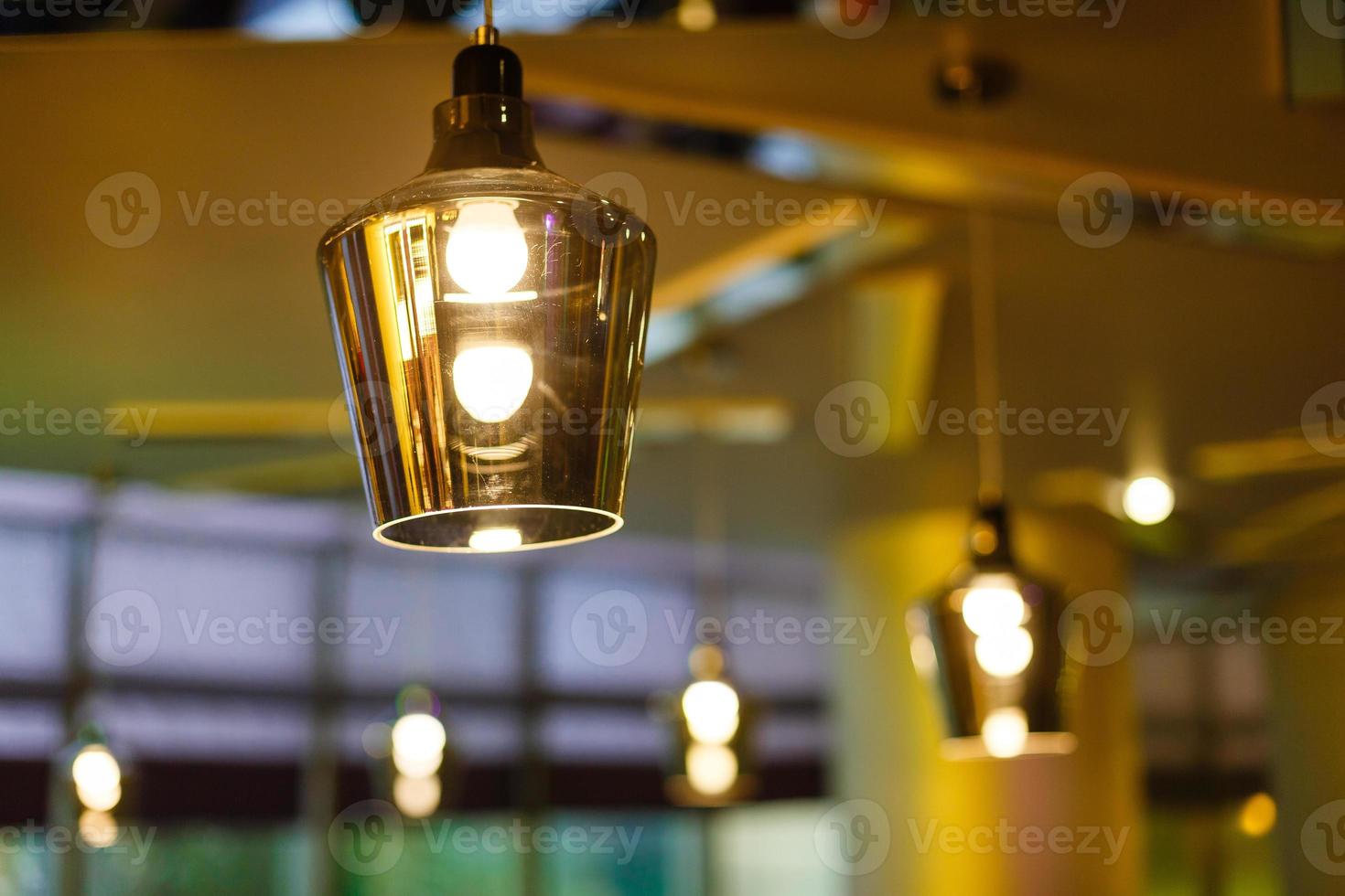 interior of restaurant with big lamps in golden light photo