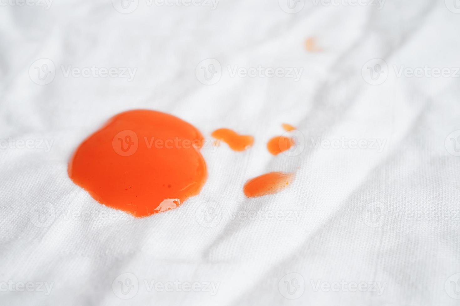 Dirty spicy sauce stain on cloth to wash with washing powder, cleaning housework concept. photo