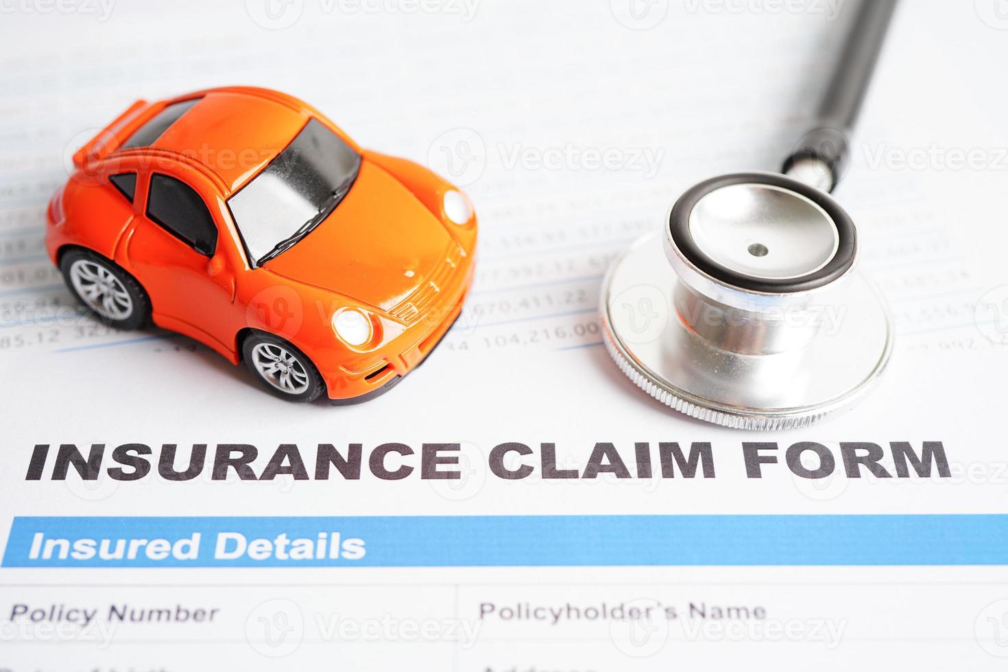 Stethoscope on Insurance claim accident car form, Car loan, insurance and leasing time concepts. photo