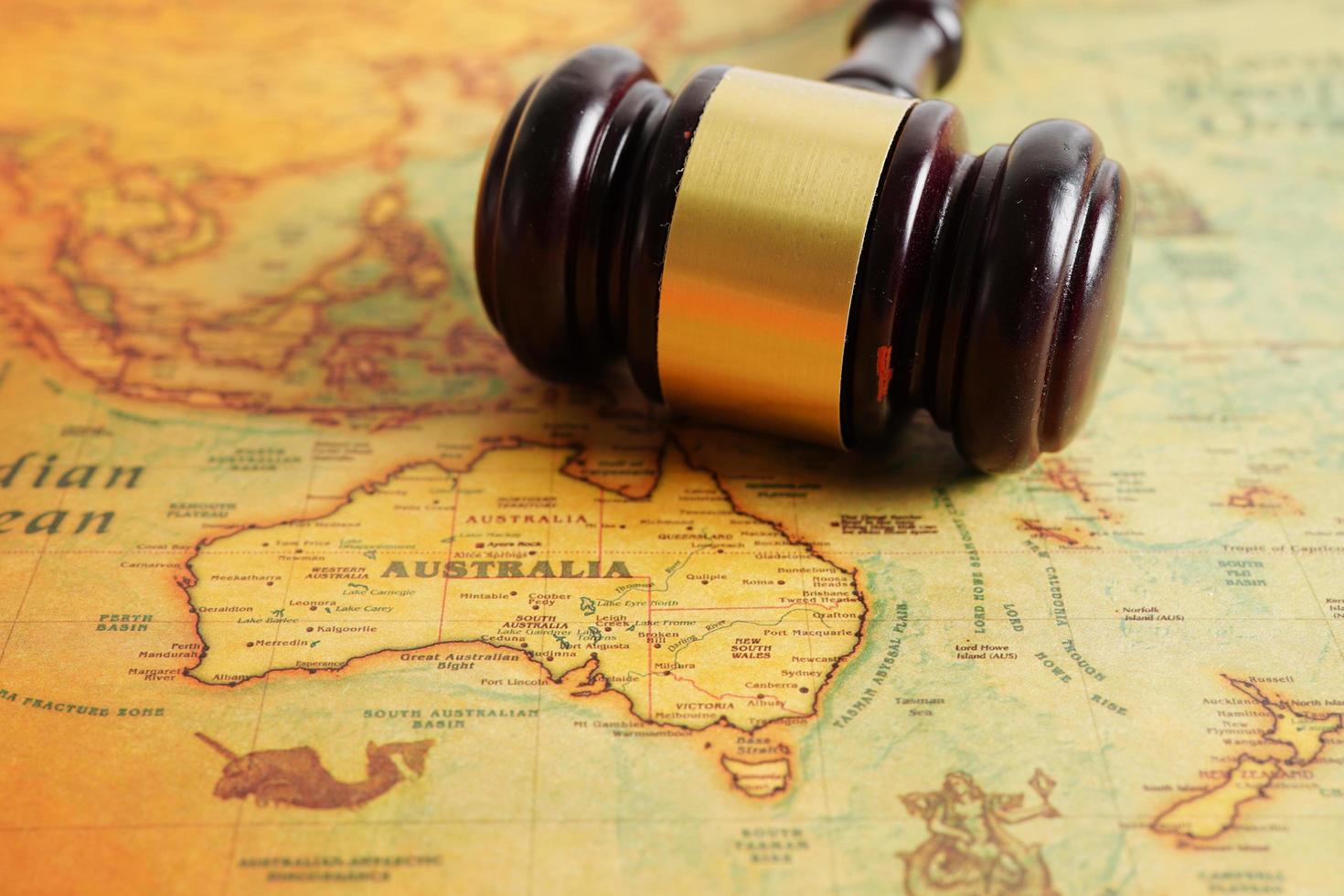 Bangkok, Thailand - December 15, 2021 Judges gavel on ancient vintage world map, international law concept. photo