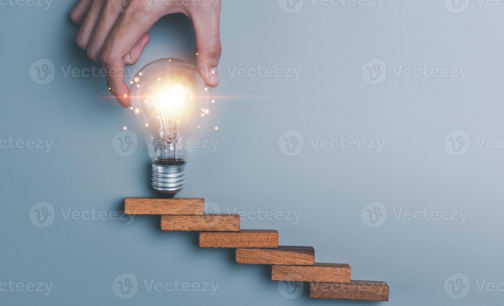 light bulb in human hand, business growth success concept, Ideas for progress in development with strategies and clear goals, development planning for growth systematically photo