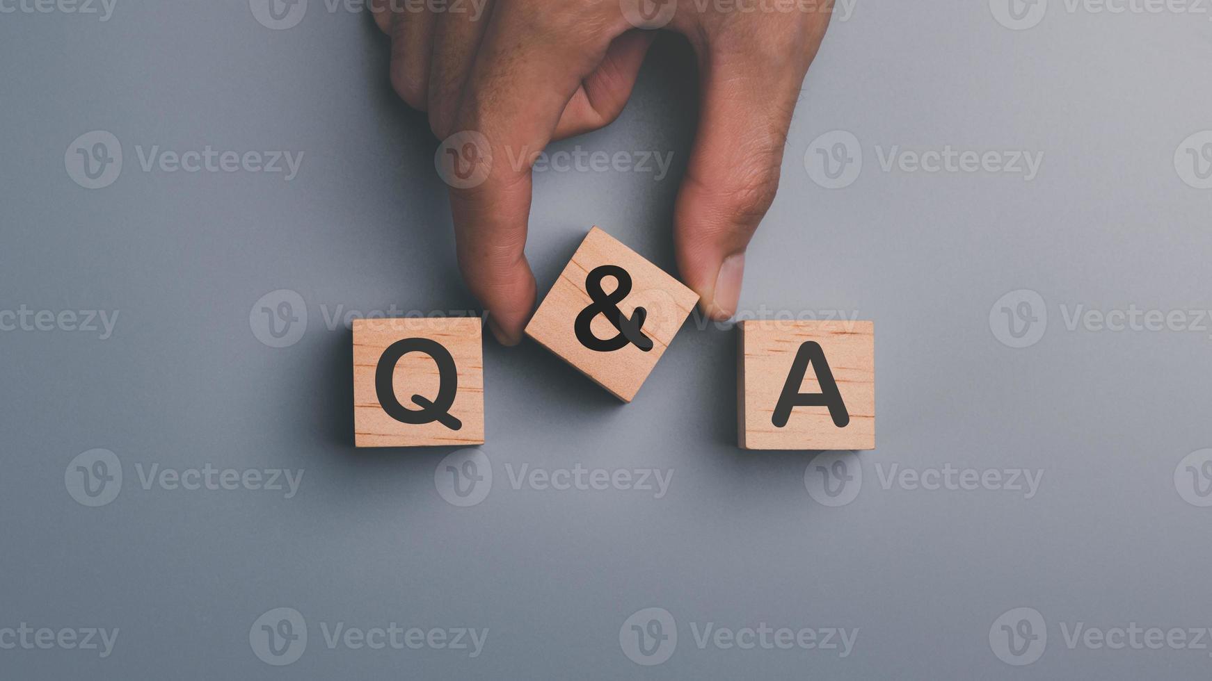 Wooden blocks and human hands ,concepts to find answers ,Question Ask ,getting help in solving problems, Q and A word with wooden cube block ,frequency asked questions photo