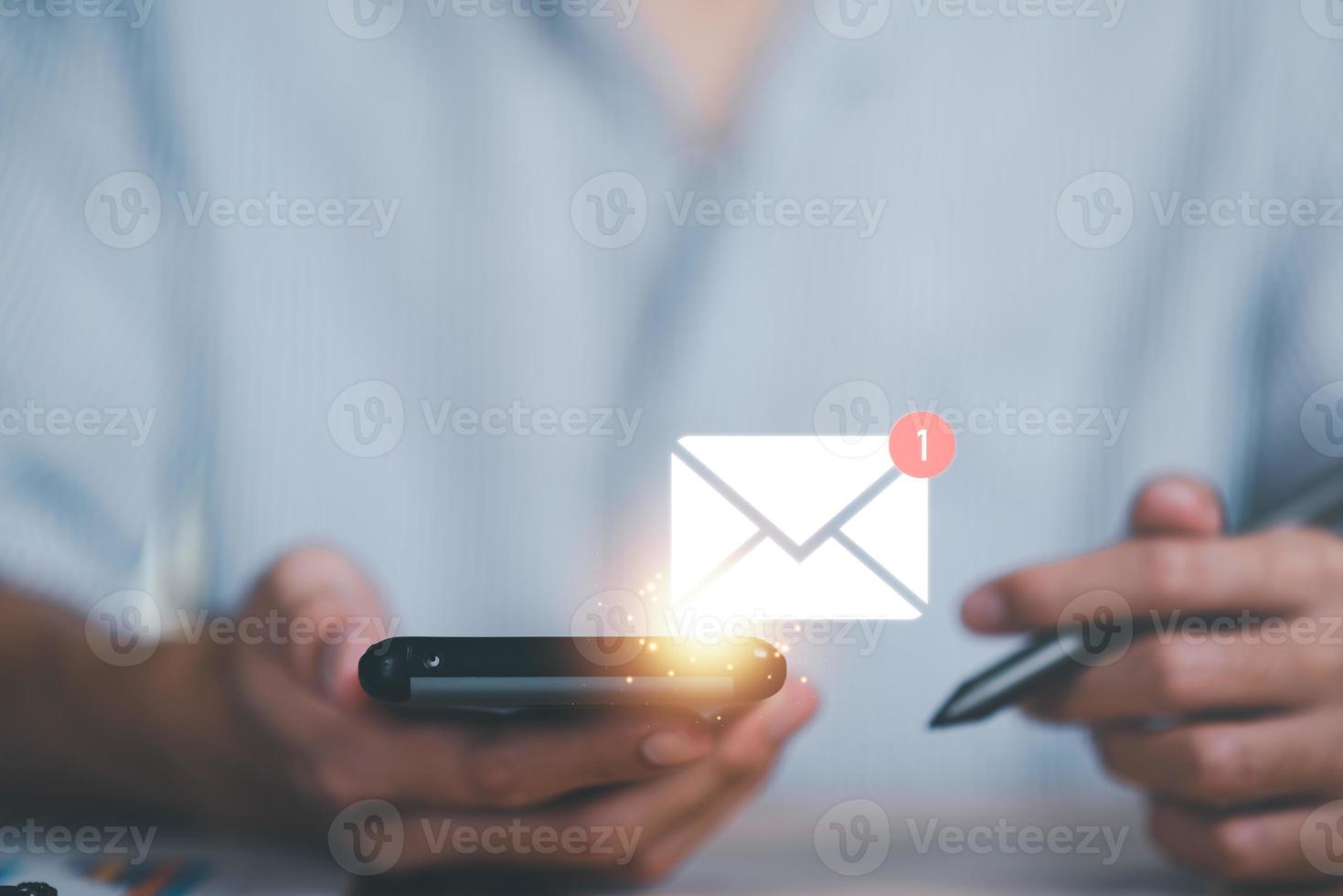 man reading electronic mail from smartphone,Email marketing and newsletter concept,Digital communication with email messages,Sending and receiving messages online with the email icon photo