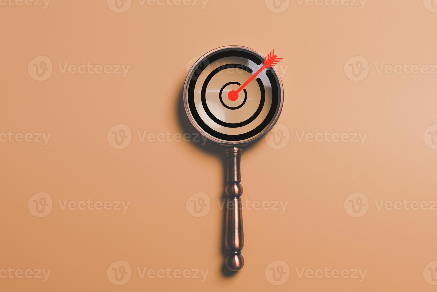 magnifying glass and arrow icon hits center of dartboard target,Setting business goals and focused concepts, Organizational growth and objectives, Competitive marketing strategy planning management photo