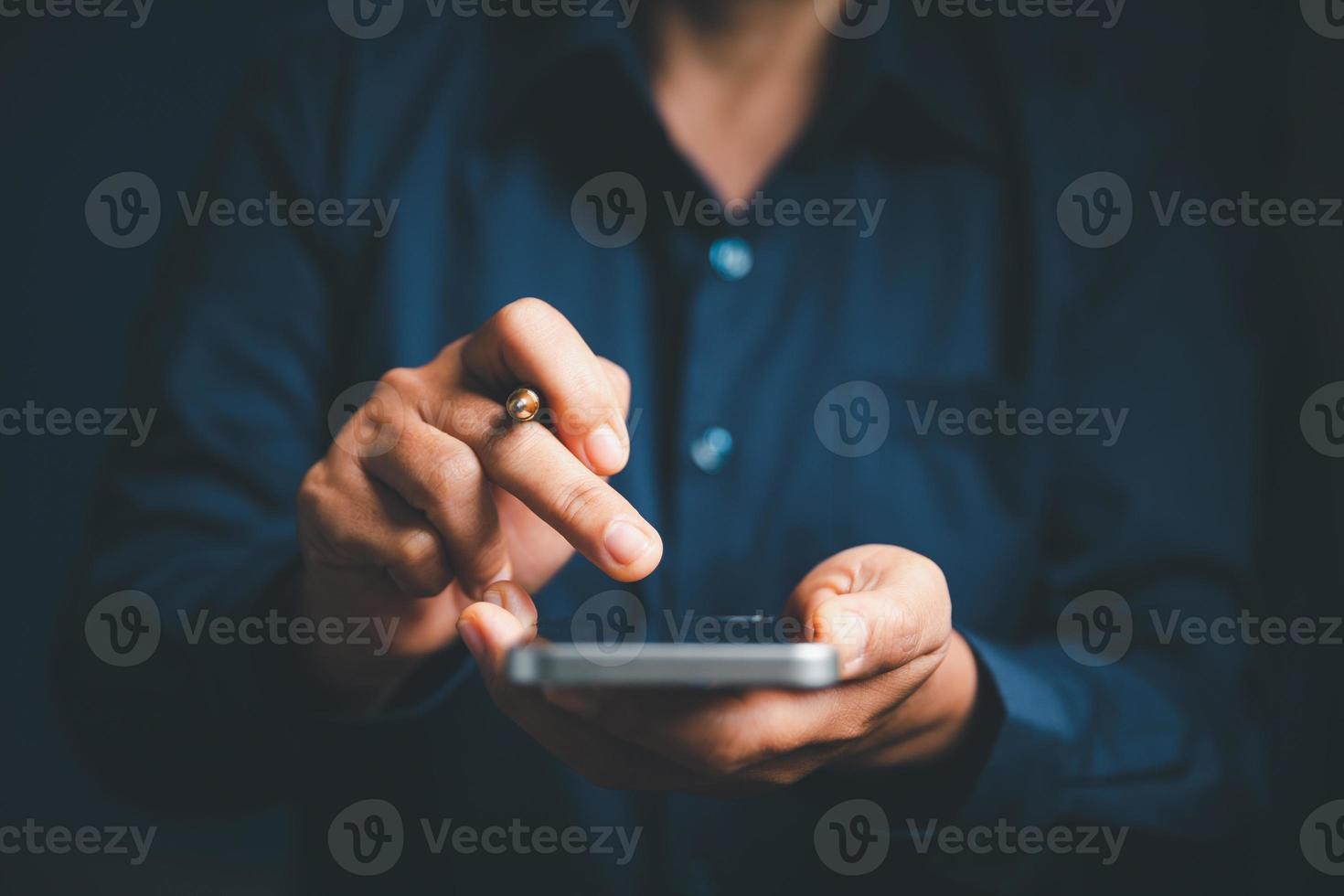 Closeup of businesswoman hand on empty dark blue background in office for design work, insert icon bundle or business technology symbols or other. selective focus on hand. female online working photo